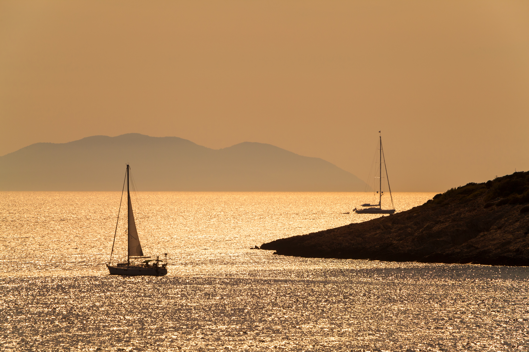 Sailing yacht on the Adriatic at dusk, calm water and open horizon