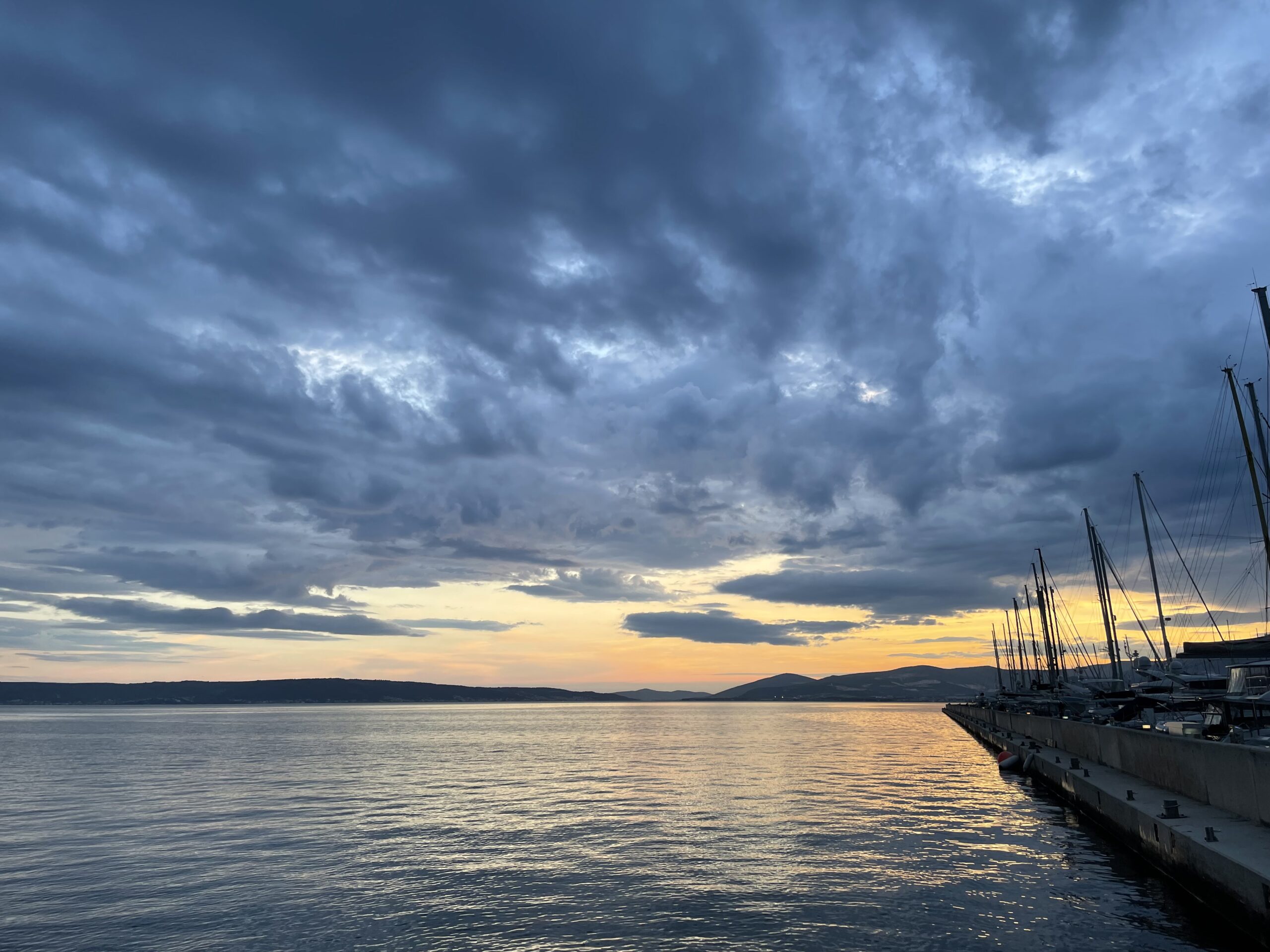 Sailing yacht at a Dalmatian harbour at first light — a different setting begins here